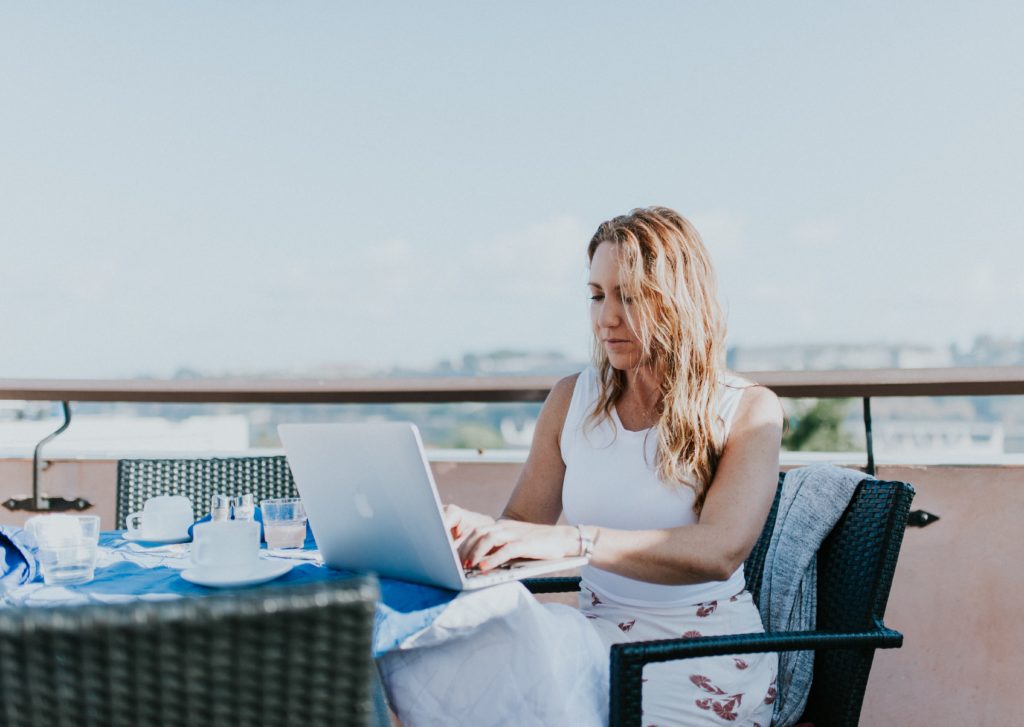 woman on balcony self-isolating during the Coronavirus crisis